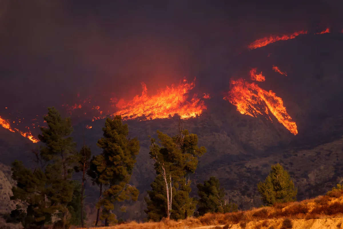 Smoke and flames rise, firefighters and airplanes battle the blaze