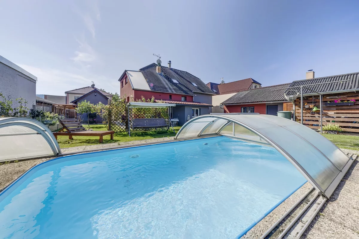An outdoor swimming pool with a canopy on the site of a house in the Czech Republic in the town of Zdice