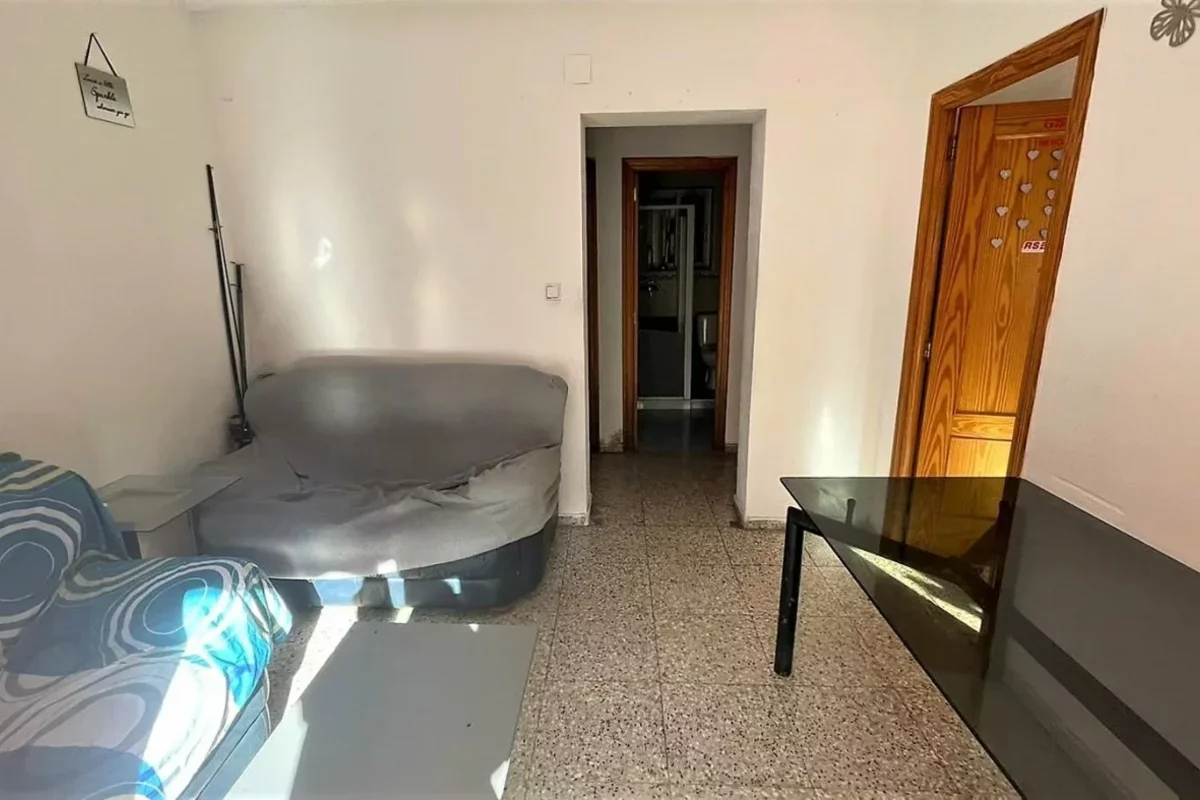 Sofa and table in the living room of a small flat in Spain