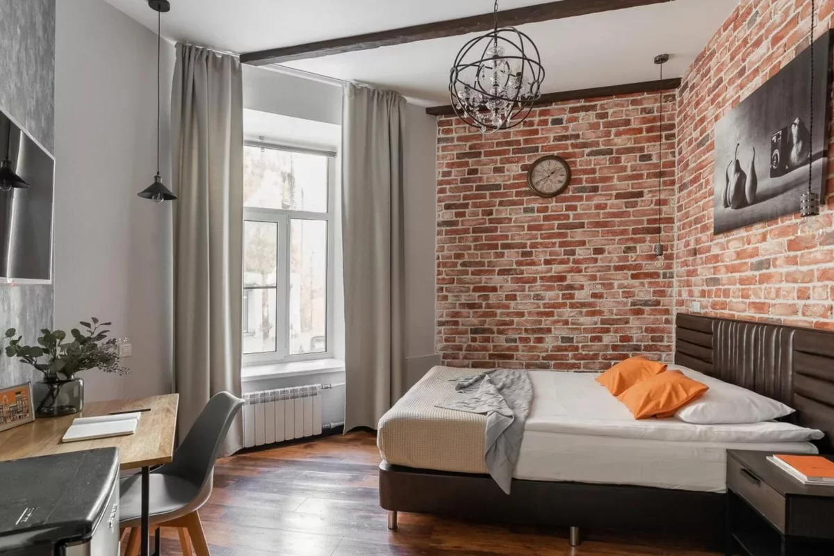 A hotel room with a brick wall