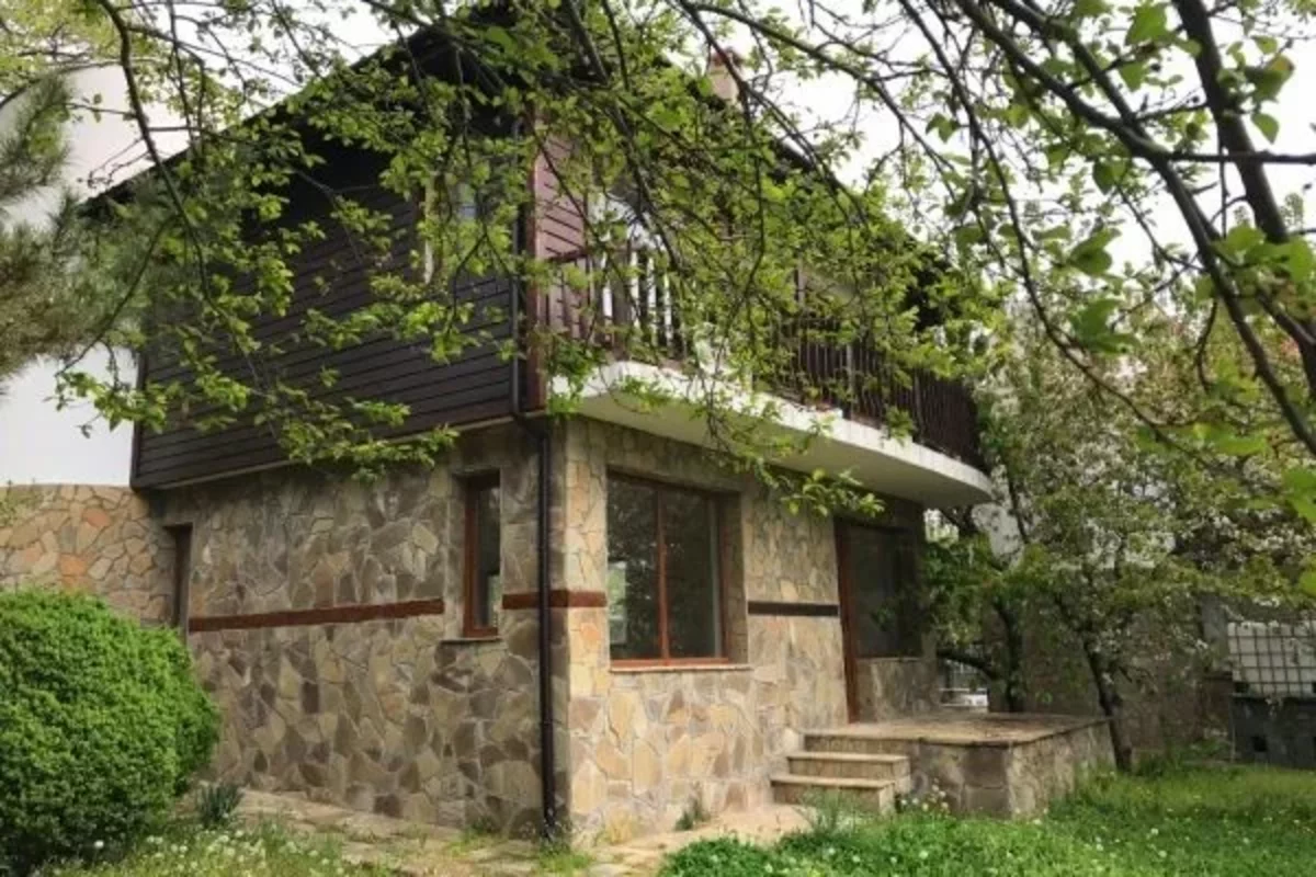 Stone facade of a two-storey cottage in Bulgaria