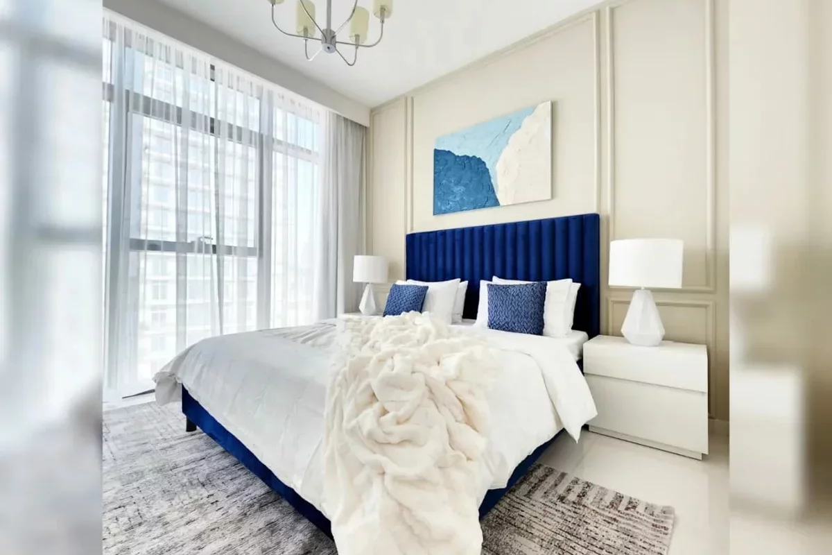 Large bed with soft blue headboard