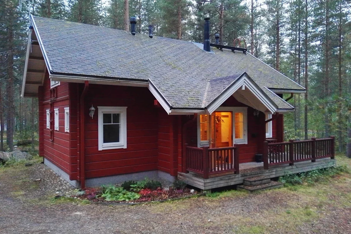 Red facade of a house in the forest in Finland