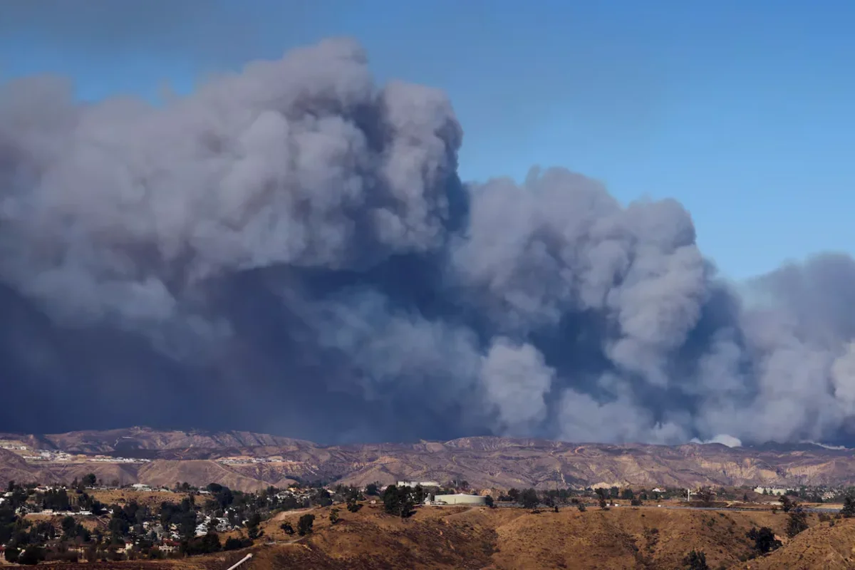 A cloud of smoke from the fire is rising