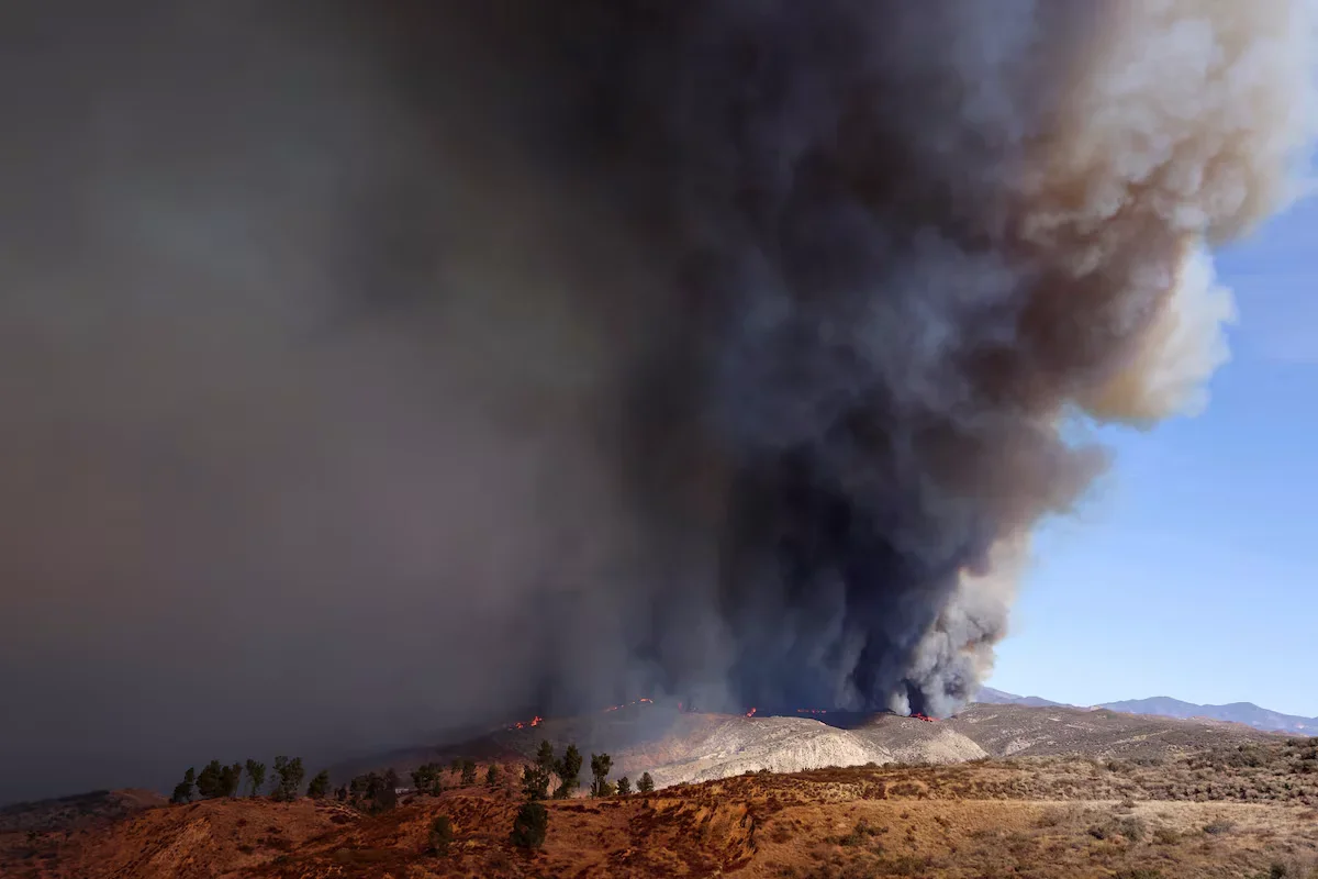 Smoke and flames rise, firefighters and airplanes battle the blaze