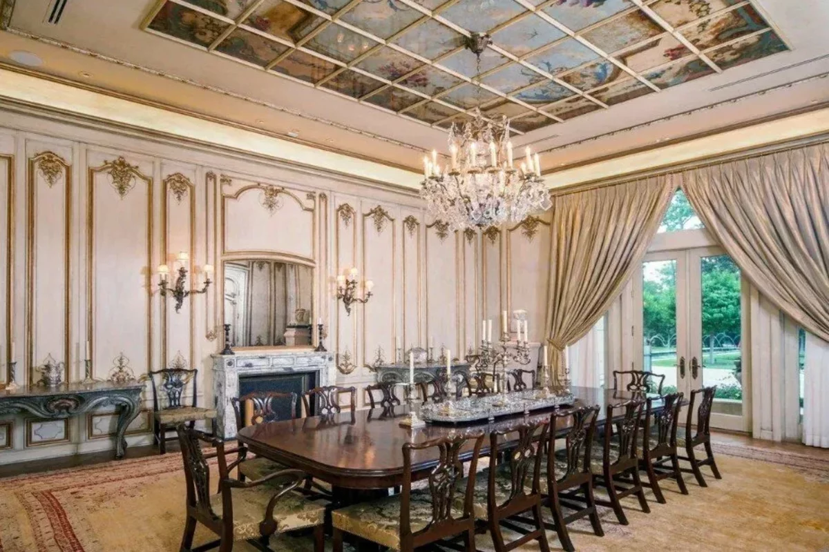 Dining room with vintage furniture and fireplace in a mansion in the USA