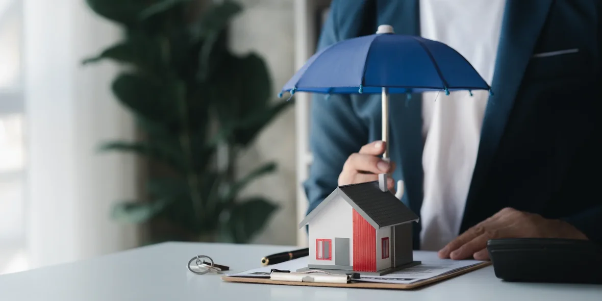 Model of a house with an umbrella