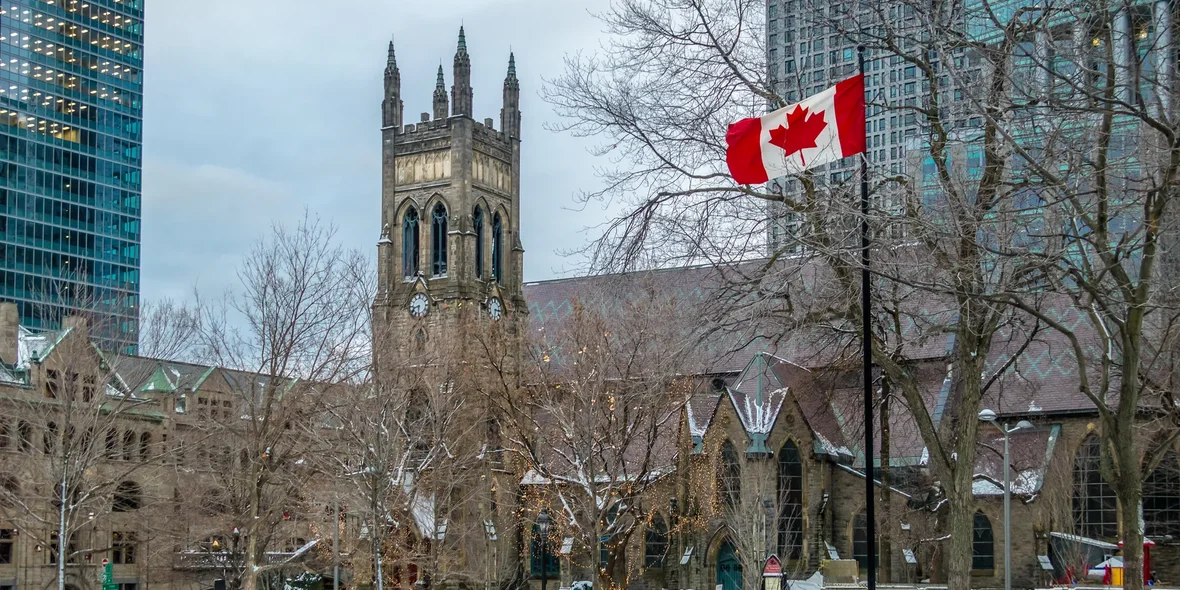 St George's Anglican Church in Canada Square with the flag - Montreal, Quebec, Canada