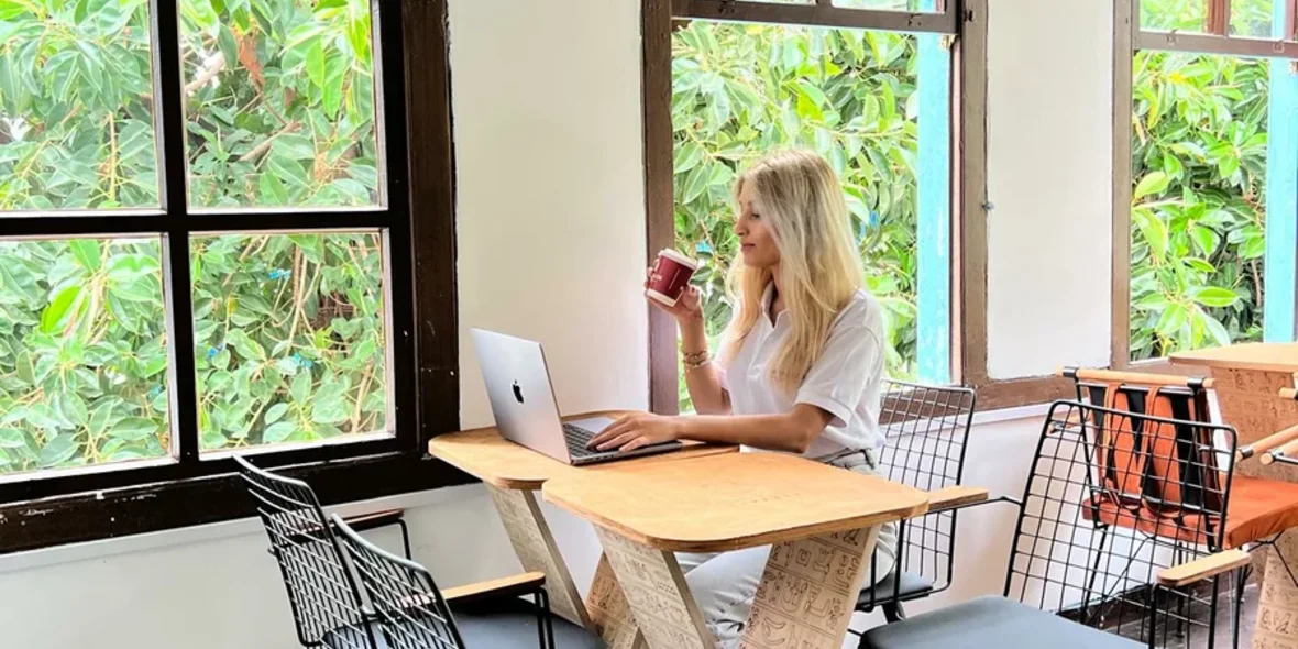 The girl drinks coffee and works in a cafe