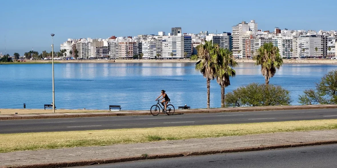 Woman cycling along the coast of Montevideo, Uruguay