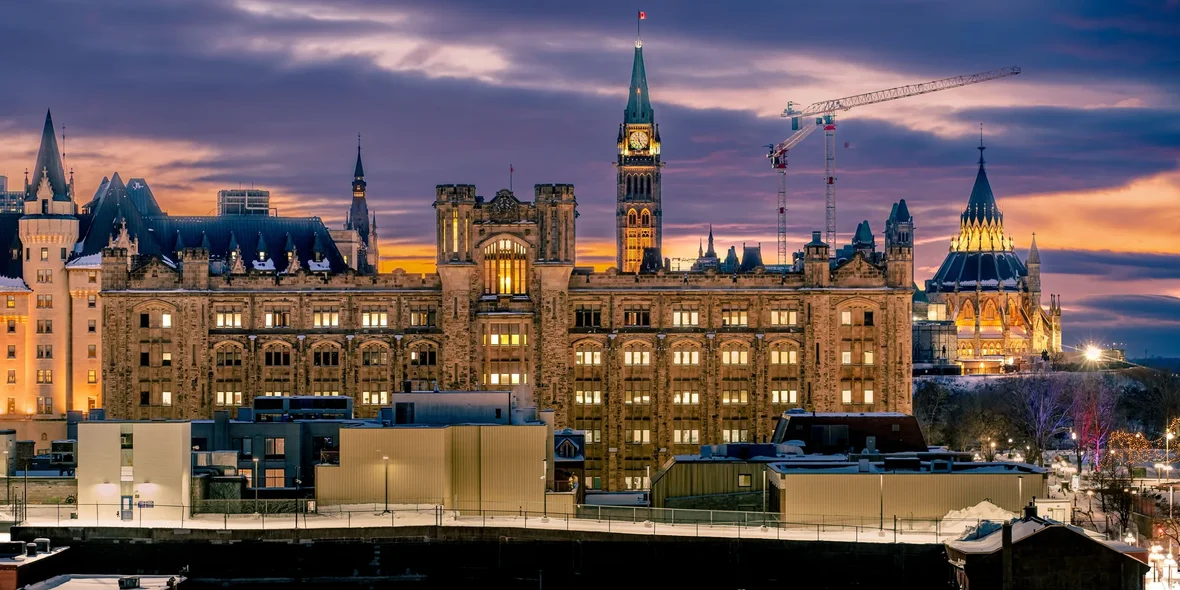 The government building on Parliament Hill in Ottawa, Canada, captured against a sunset sky