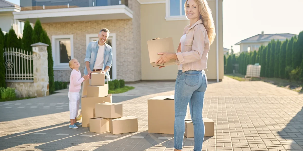 Young family in front of a new house