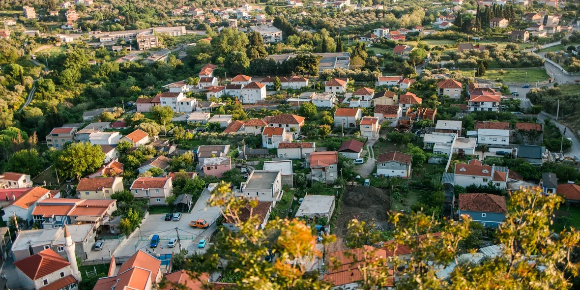 panoramic cityscape of Bar in Montenegro with road and houses, aerial view