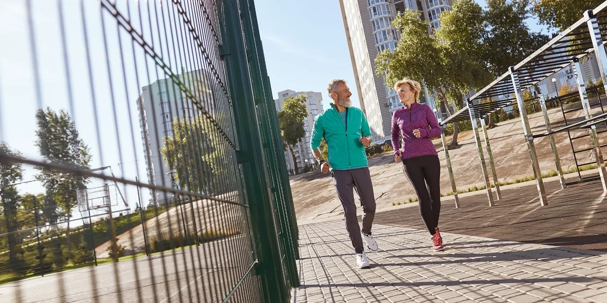 Active mature couple in sportswear running together