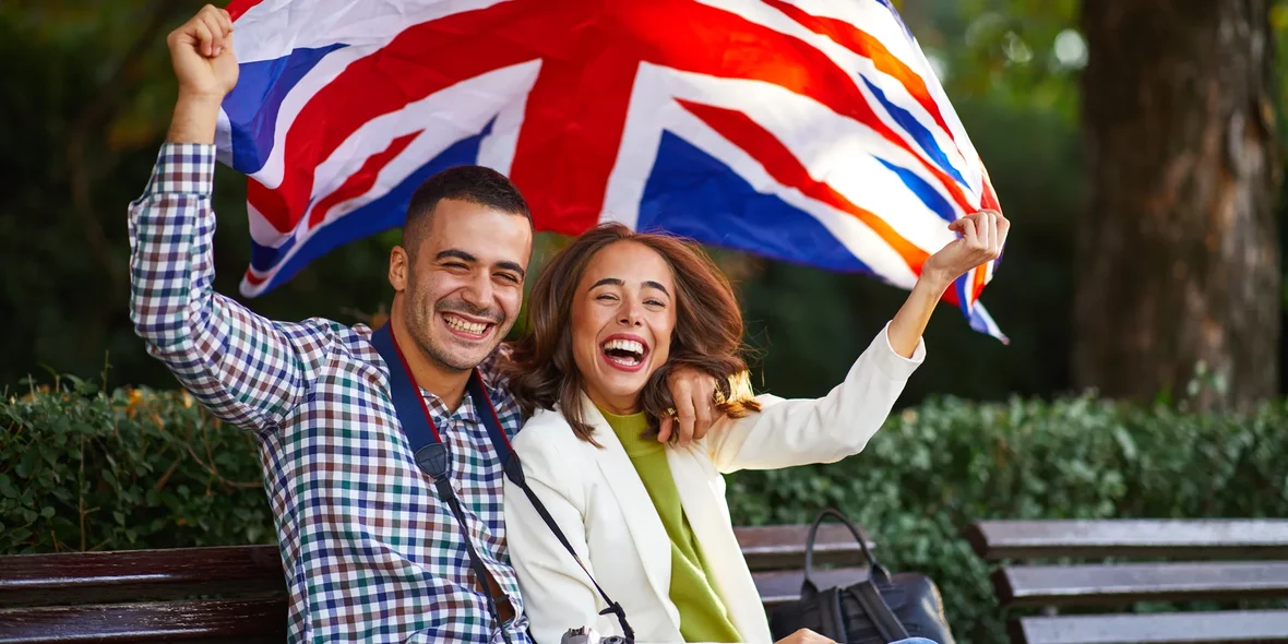 couple of tourists with UK flag where English is spoken in Europe