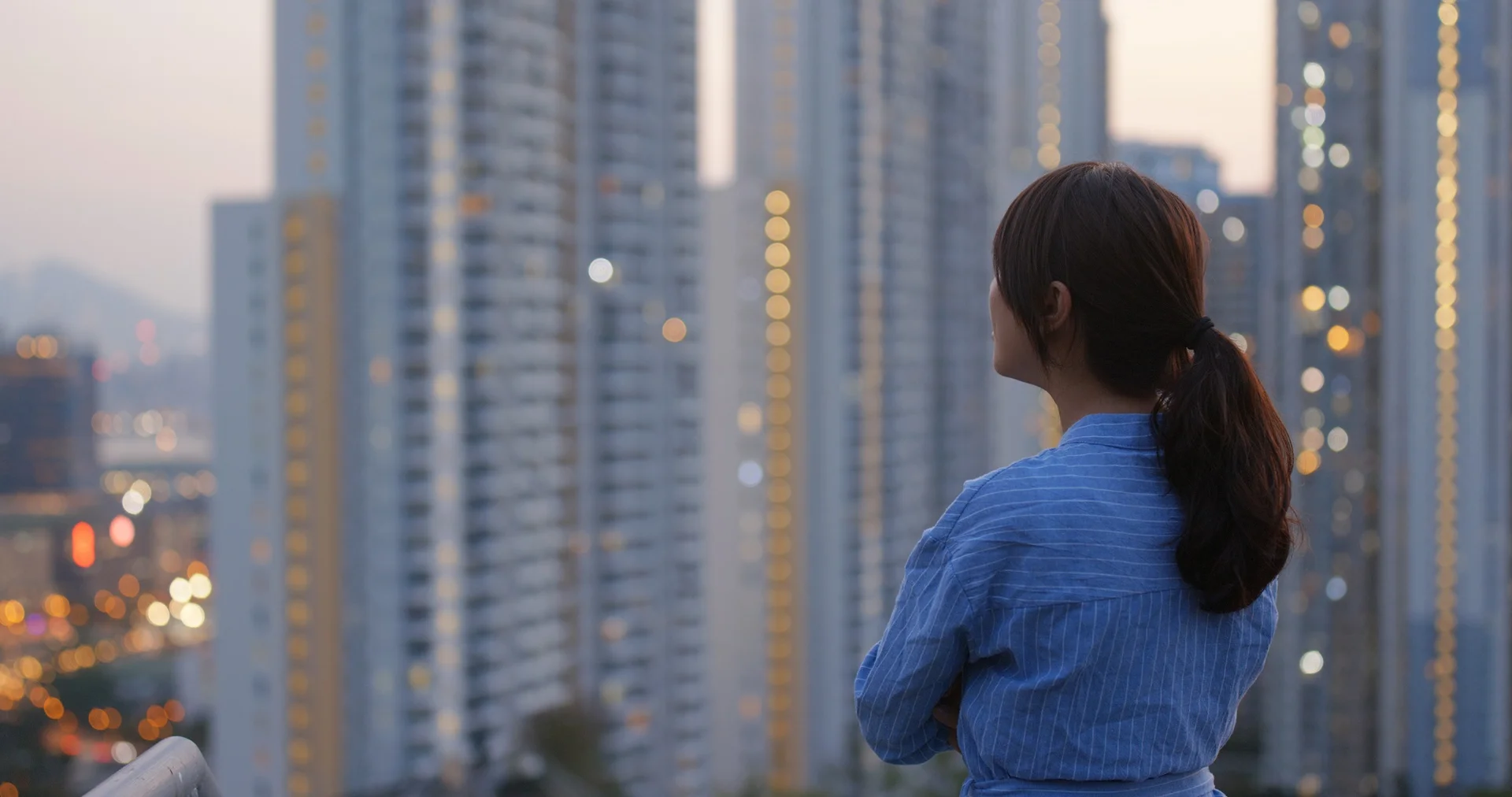 woman watching the sunset in the city