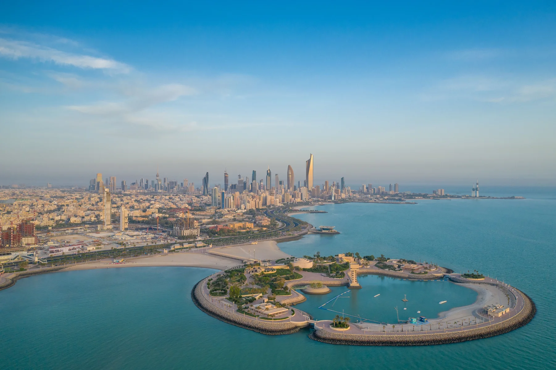 Green island with Kuwait City panorama in the background