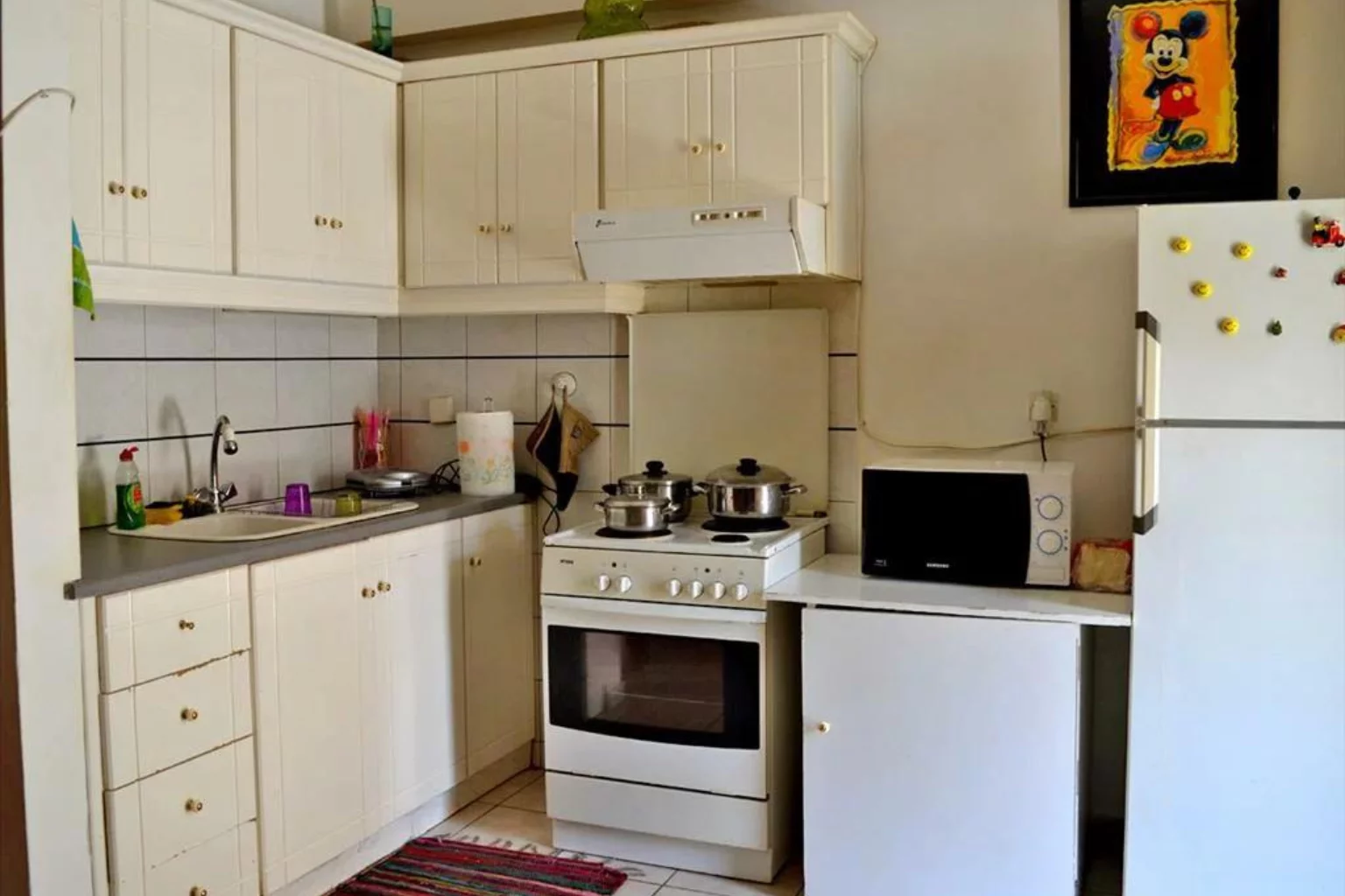 white kitchen in a studio flat in Greece